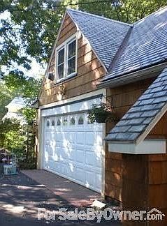 Attached Garage
						:
						Includes workshop cabinets, new garage door, brick-paver entrance.