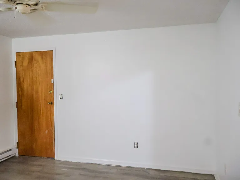 Living Room / Living Space _ Renovations Nearing Completion. New Baseboards Will Be Installed and the Fire Escape Door Will Be Freshly Painted.