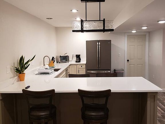 Kitchenette with full size refrigerator, Full size dishwasher, sink,Toaster oven, & 2 burner electric cooktop *This space does not include an oven or stove.