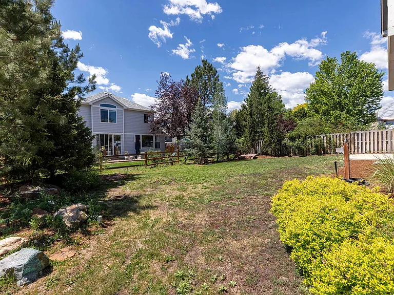 The expansive backyard offers plenty of room for recreation, gardening, pets, or simply enjoying the outdoors.