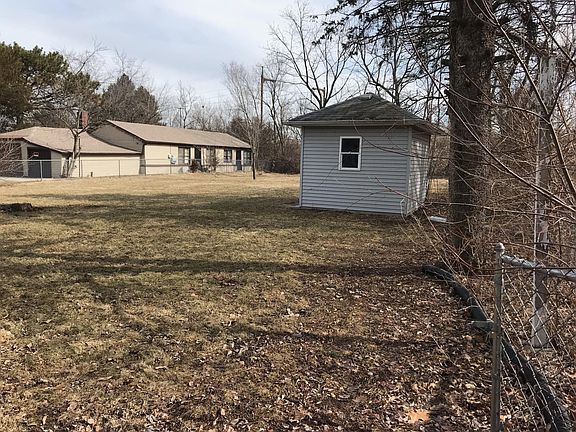 Backyard from house. Shed with single garage door opening.