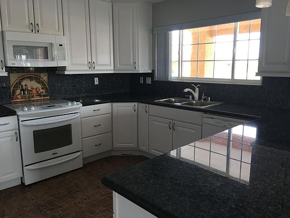 kitchen with granite counter tops and upgraded appliances