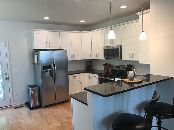 Modern kitchen finishes with eat up breakfast bar and pende