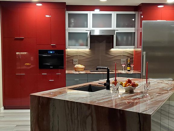 European designer kitchen with high-end steam/convection combo oven, induction cooktop, microwave, convection toaster oven, integrated refrigerator/freezer, and others