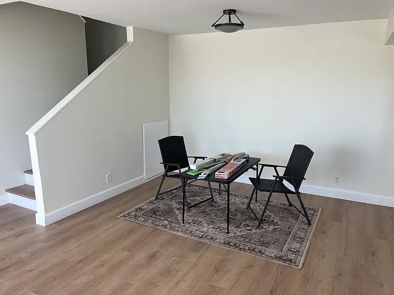 Dining area with additional storage under stairwell.