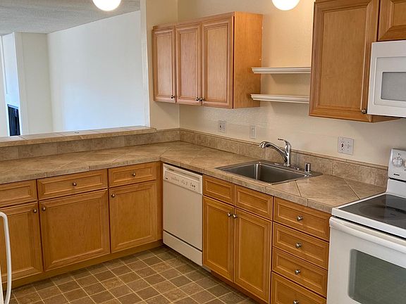 Eat-in kitchen with nice appliances, stone countertops, and beautiful cabinets.