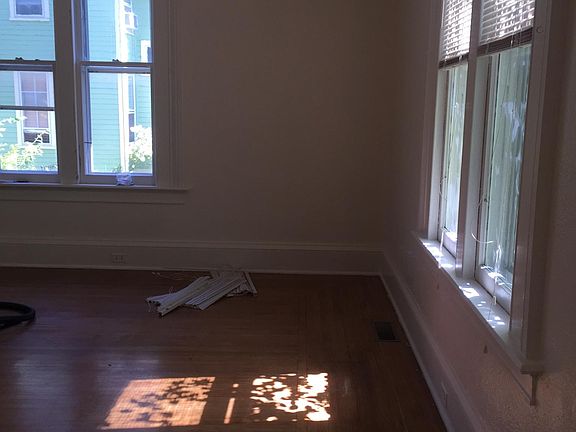 Living room has lots of natural light and warm wood floors