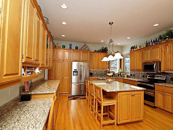Look at this kitchen!   Granite, hardwood floors, SS appliances, recessed lighting, center island, and more
