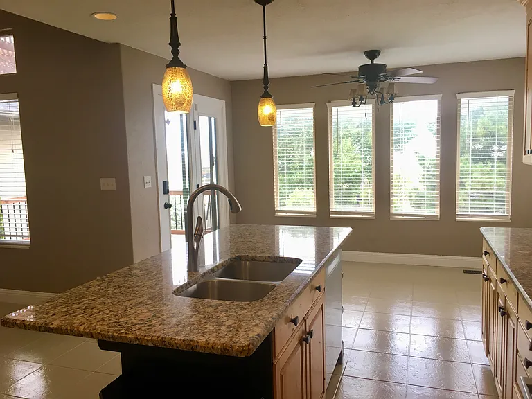 Kitchen with island and brand new epoxy coated tile flooring.