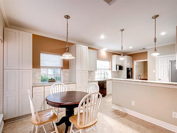 Open, updated 9 x 12 kitchen area + casual dining space + granite-topped breakfast bar that seats 3- 4.