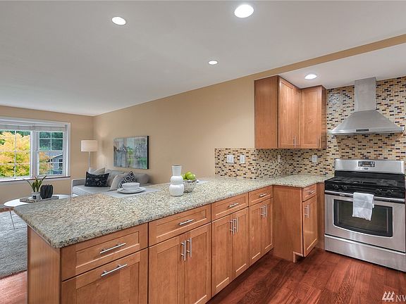 Updated kitchen with granite counters, full height tile backsplash. 