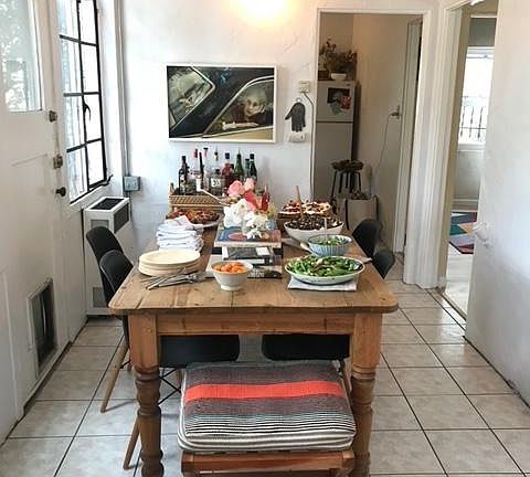 Large table with food and entertaining guest!