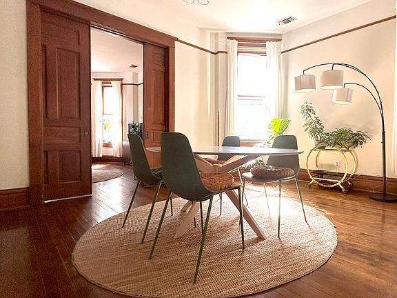Pocket doors lead to dining room with bay