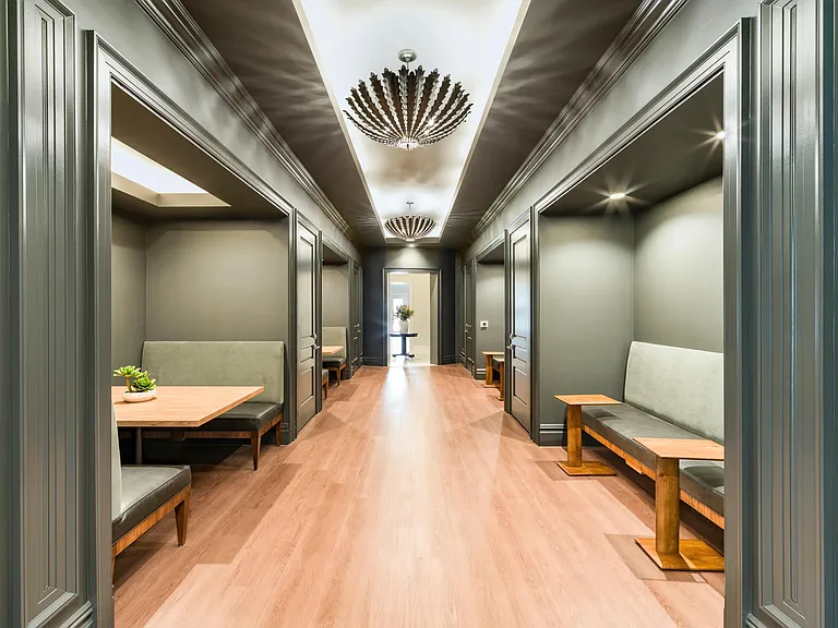 Library with private alcove seating, built-in benches, and refined lighting creating quiet spaces for work, or focused downtime.