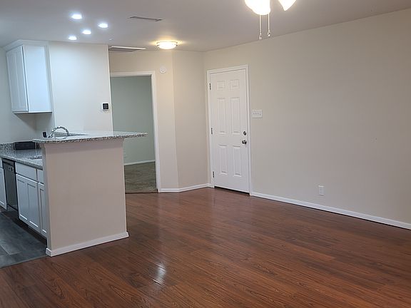 Livingroom looking at front door and bedroom door