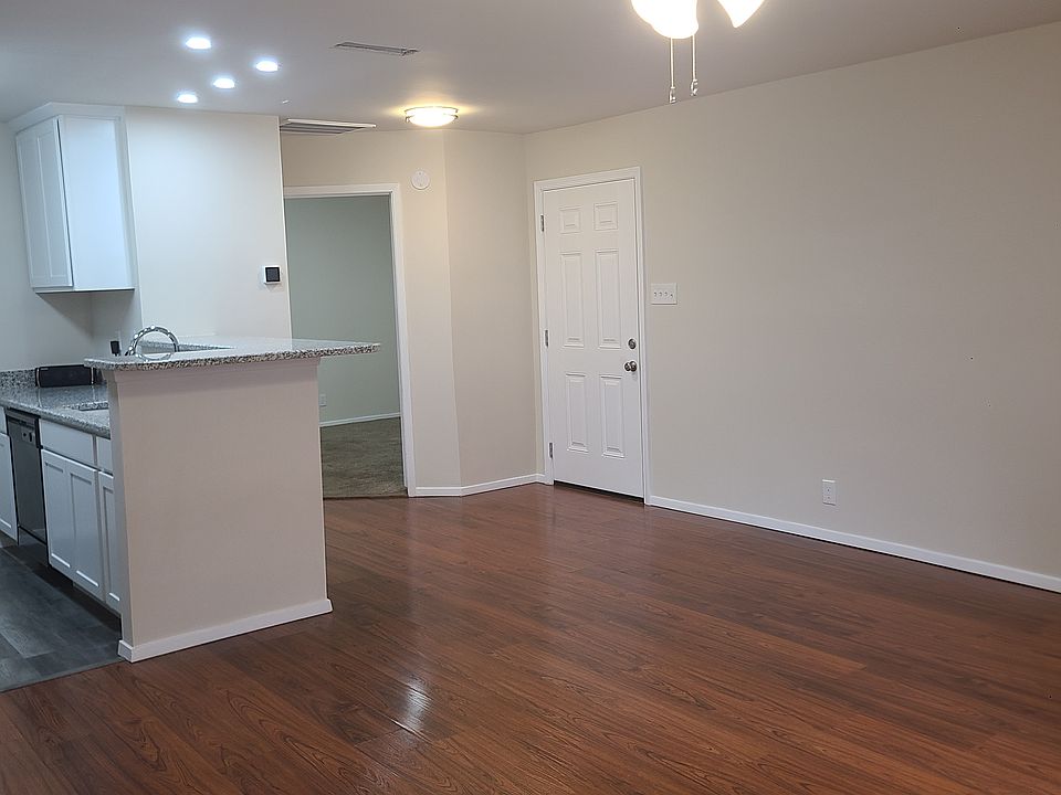 Livingroom looking at front door and bedroom door