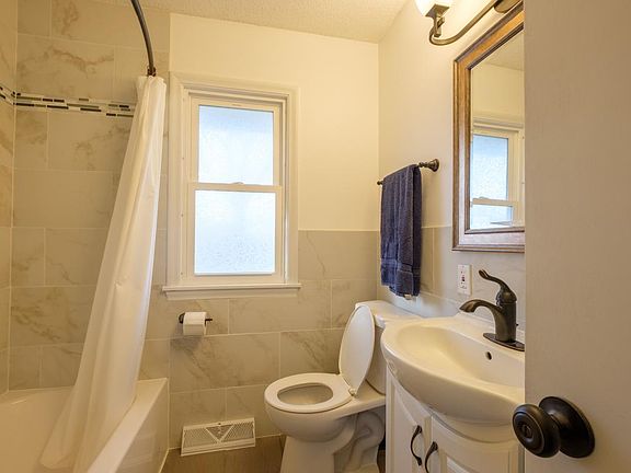 freshly renovated bathroom with porcelain tile an lots of st