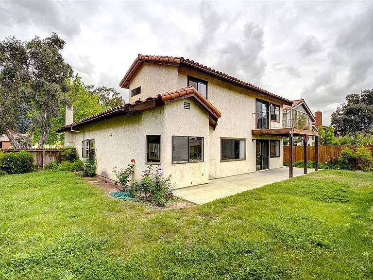 Rear portion of the house where kitchen and family are and a large backyard