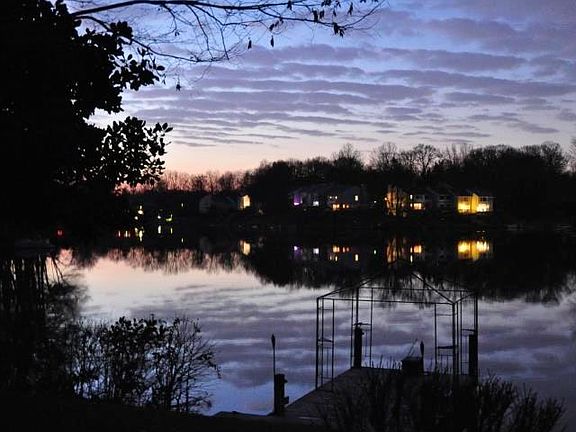 Lake behind house at dusk