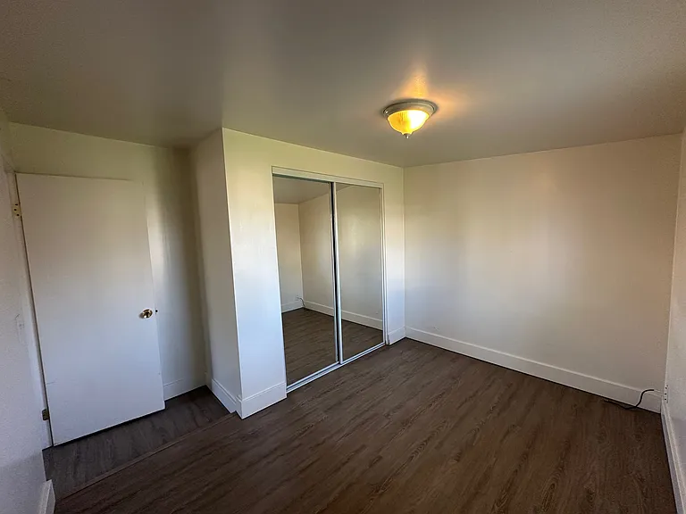 bedroom with mirrored closet doors