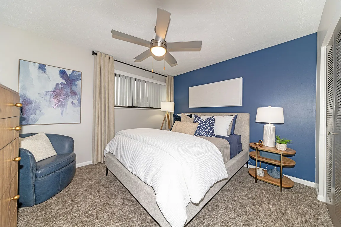 Cozy bedroom with carpet and ceiling fan