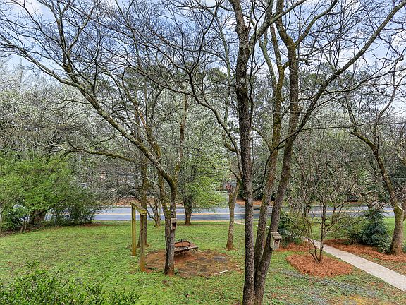 Front yard tons of birds and beautiful trees and flowers