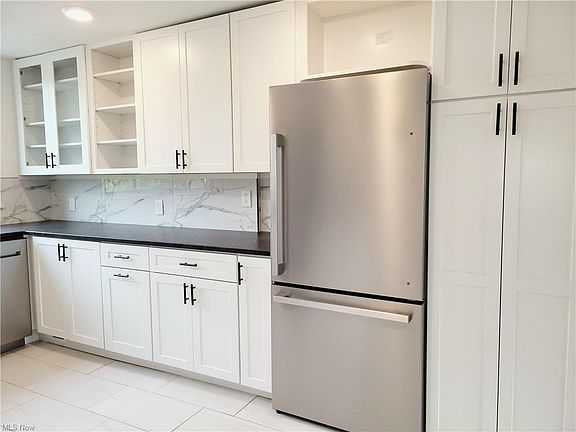 White soft close cabinets throughout the kitchen.