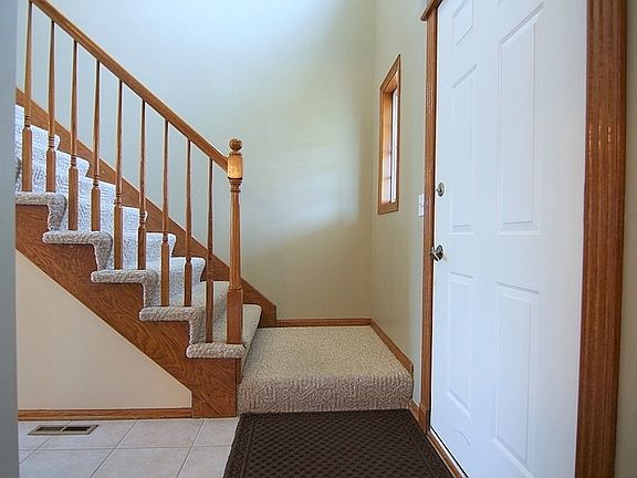Front Entry with Coat Closet and Open Staircase