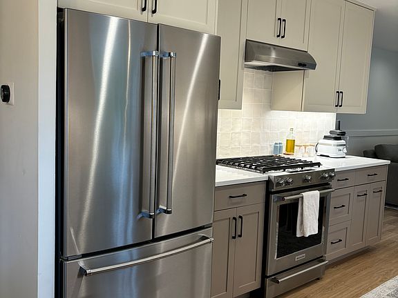 Luxurious Kitchen Aid double french door refrigerator with water filtration inside. Freezer with automatic ice machine.