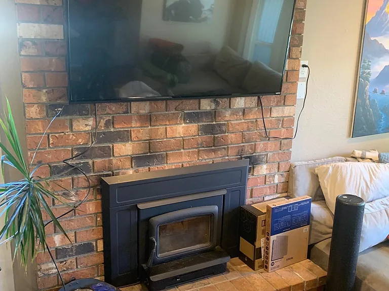 Wood stove insert in the living room keeps the home toasty and cozy all winter.