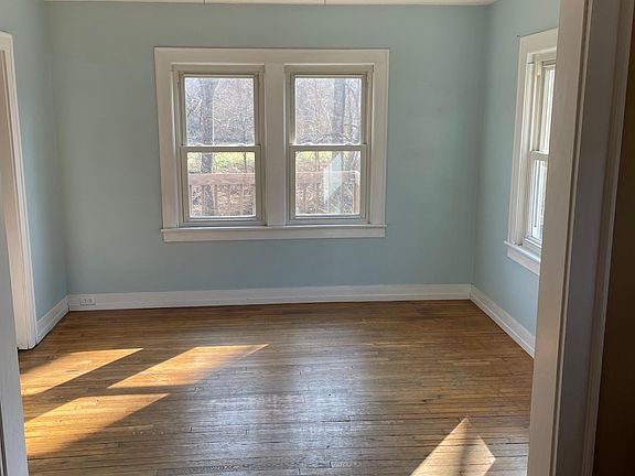 Dining Room, has four windows, the kitchen is to the left