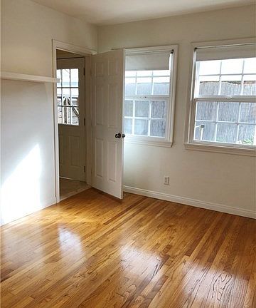 Third Bedroom with Gleaming Wood Floor and Recessed Lights.