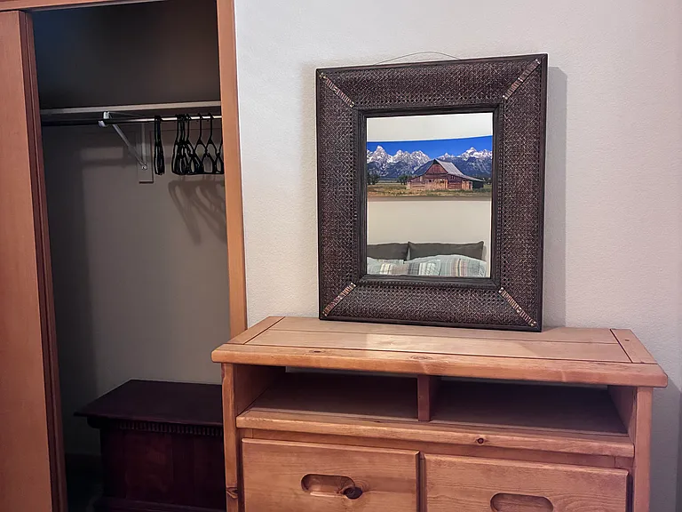 Guest bedroom with additional dresser and storage.