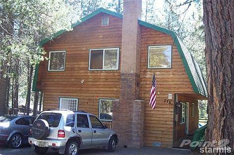 Front view of home, entry in side door. Parking for 3 cars.