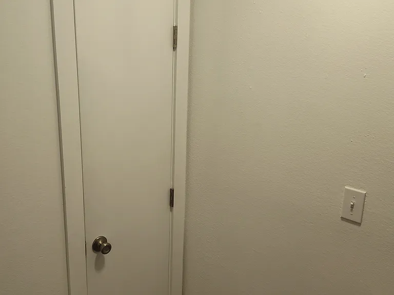 Top of the stairs looking at the linen closet door.