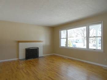 There's an attractive wood burning fireplace to add that special cozy touch!  The large picture window allows for plenty of natural light to flood into this character filled sizable room!