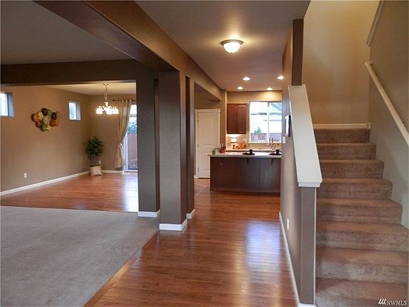 This is the view of the main living area as you enter the front door.  The hard wood floors sparkle with light and the architectural columns and open finished beams give you the feel of a privacy division, yet does not interrupt conversations and entertai