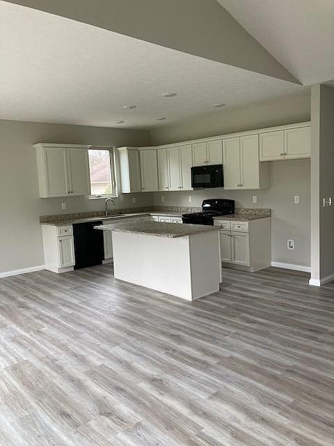 Open Kitchen with plenty of Cabinets and Counter Space. Appliance include Oven, Dishwasher, Microwave and Refrigerator.
