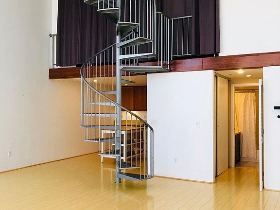 Living area with loft bedroom curtains closed