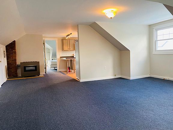 Open living area looking to kitchen then bedroom