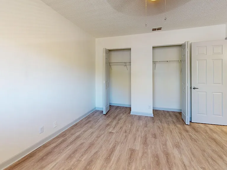Explore the spaciousness of this bedroom, complete with stylish wood floors and ample closet space.
