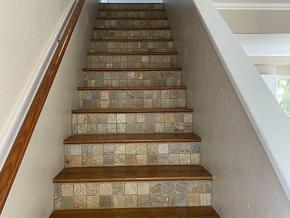 Stairway to bedrooms and 2 full bathrooms