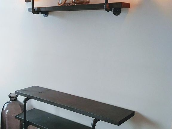 Wood/pipe entertainment center remains..