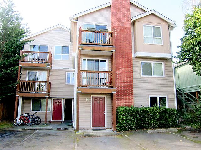 View of Unit E: red door on right, with parking space nearby