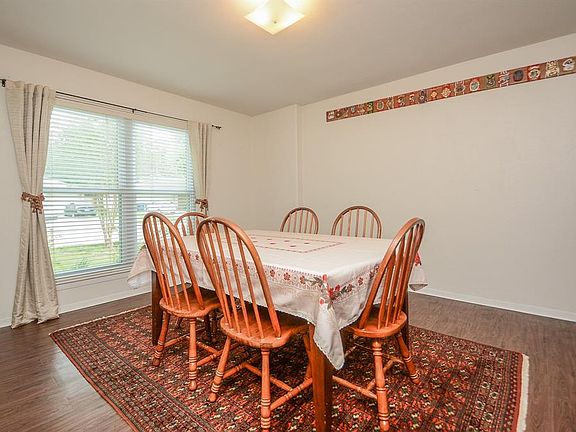 Formal dining room perfect to entertain your guests. The dining room is right off the entrance of the home, is spacious in size, and boasts with tons of natural light. The beautiful flooring is the same throughout most of the home.