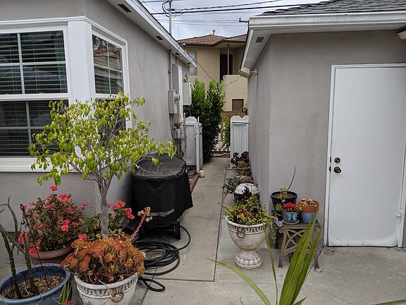 Garage door on the right. Windows to the left are for the second bedroom of three. This shot shows a distant view of the tankless water heater - unlimited hot water!