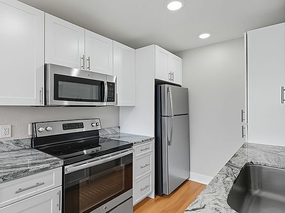 Modern kitchen with stainless steel appliances and granite countertops