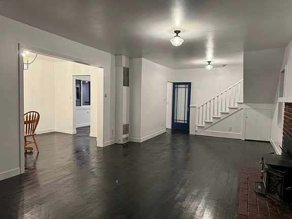 Through the front door, you are greeted by the large downstairs family room. Big windows provide wonderful afternoon sunlight.