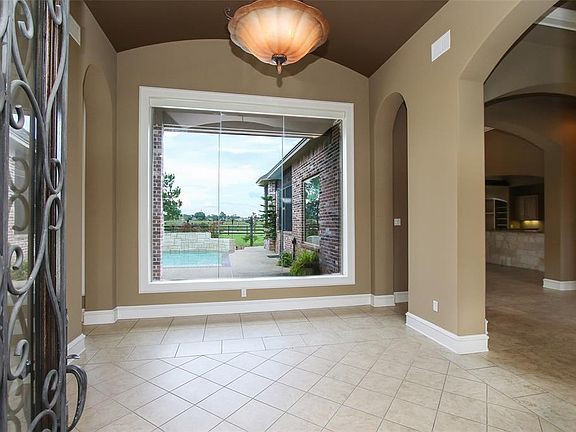 Greeting you in the entryway is a beautiful picture window with a view of the pool, and pond!