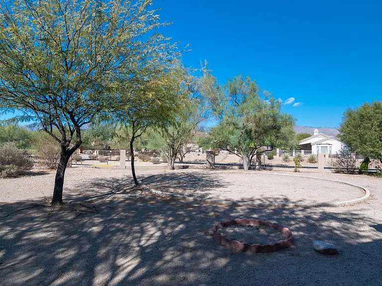 back yard with view fence and mountain views; vegetation destroyed by previous tenant / plan to restore